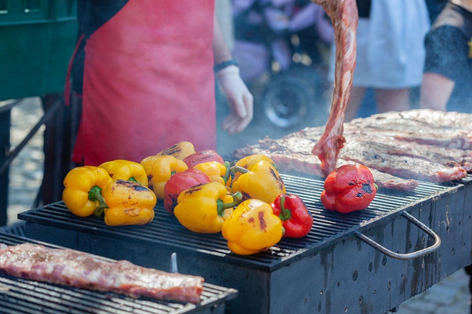 Grill med røg, farverige peberfrugter, tomater og kød